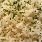 Juicy, delicious white rice garnished with herbs.