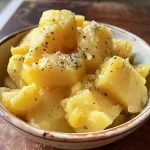 Textured sweet potato mash with a glossy finish in a shallow plate.