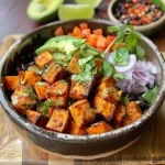 Close-up of a vibrant chili-lime sweet potato and black bean bowl.