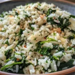 Close-up of a skillet filled with juicy garlic spinach rice.
