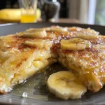 Close-up of a golden-brown Panqueca de Aveia e Banana on a plate.