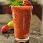 Close-up of a glass of fresh strawberry juice with mint leaves, taken with an iPhone 15 Pro.
