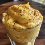 Mousse de maracujá saudável em um recipiente de vidro, com textura cremosa e polpa de maracujá por cima.