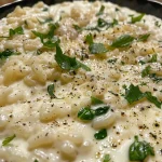 ['Prato de arroz cremoso com espinafre, apresentado de lado.', 'Close de arroz cremoso enriquecido com espinafre fresco.', 'Detalhe de um prato de arroz cremoso com espinafre e queijos.', 'Arroz cremoso com espinafre em foco, com queijos gratinados.']